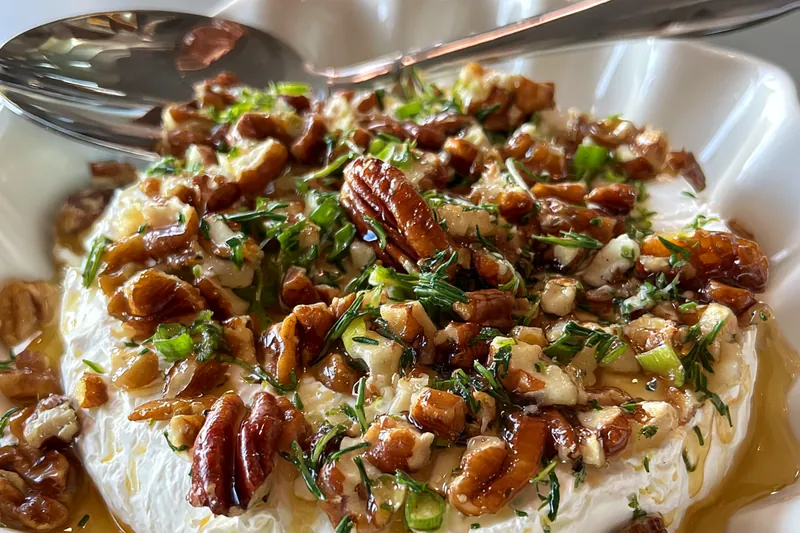 A vibrant selection of fresh ingredients for making Creamy Boursin Cheese Delight, including herbs and cheese.