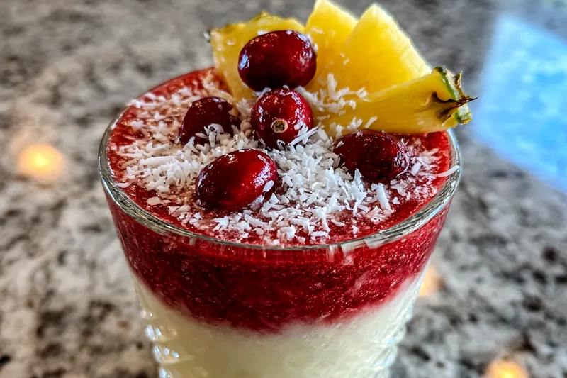 A blender filled with the ingredients for Frosty Tropical Colada Delight, ready to be blended to perfection.