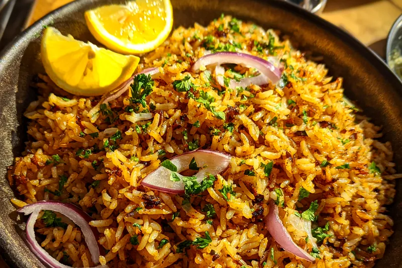 Ingredients laid out for Golden Butter Rice Delight including rice, butter, peas, and spices.